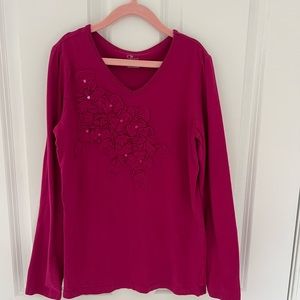 Dark pink long sleeve v neck shirt with floral accents by 1989 Place.